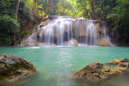 Waterfall in Erawan National Park with two big rocks in foregroundの写真素材