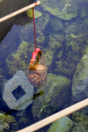 Eggs to boil in basket in natural hot spa Pha Soet near Chiang Rai, Thailandの写真素材