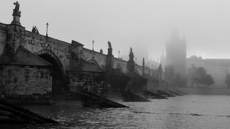Charles bridge from the side on misty morning in black and whiteの写真素材