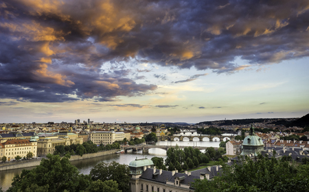Skyline of Prague bridges on Vltava river during afternoon. Storm clouds with red color. old Town, Prague, Europe.の写真素材