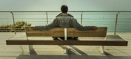 a person who observes the sea taken from behindの写真素材