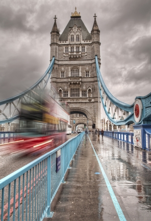 Tower bridge with movement blurred double decker bus passingのeditorial素材