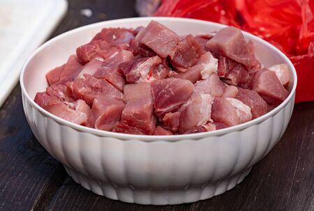 Red pork meat ready for the goulash in white plastic bowlの写真素材