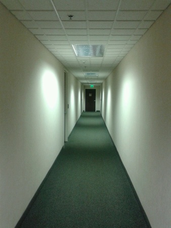 Long hallway leading to exit doorの素材
