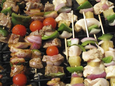 chicken and steak on skewers with vegetablesの写真素材