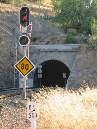 Signal lights speed restriction and distance marker at railway tunnel near Alora Andaluciaの写真素材