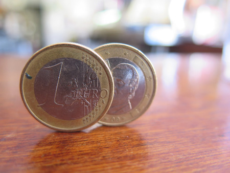 Two One Euro coins balancing on bar topの写真素材