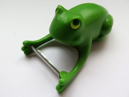 crouching Green plastic frog vegetable peeler toolの写真素材