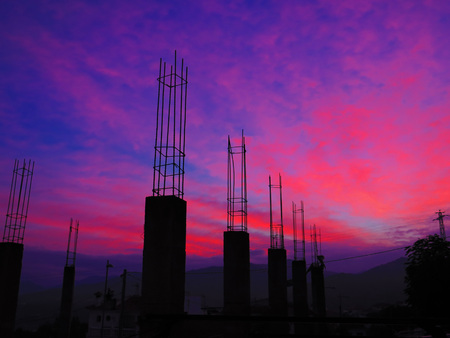 Reinforced concrete pillars reaching for the sky at abandoned building site in Alora Andaluciaの写真素材