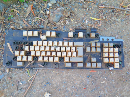 Broken and Discarded computer keyboard in country laneの写真素材