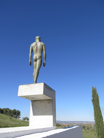 ANTEQUERA, SPAIN - JANUARY 16TH. Statue of naked man on high plinth. Antequera, Spain, January 16th 2016の写真素材