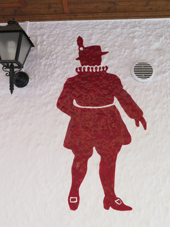 FUENGIROLA, SPAIN - MARCH 3RD. Outline of red beefeater on white restaurant wall. Fuengirola, Spain. March 3rd 2016のeditorial素材
