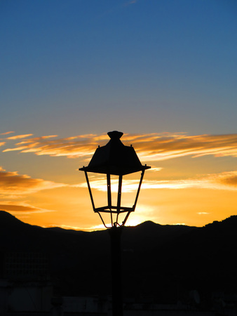Lantern seen against mountains at around sunriseの写真素材