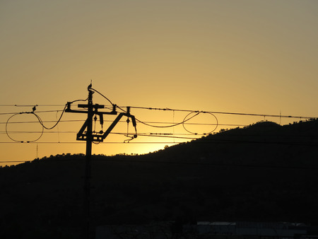 Orange Sunrise over Overhead Lines nearAlora, Andalusia