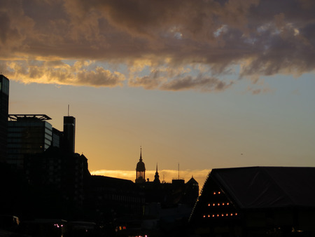 Early morning city silhouette against low hanging clouds in Hamburg, Germanyの写真素材