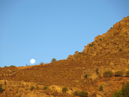 Full moon over mountain in rural Alora Andaluciaの写真素材