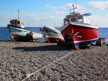 Beer, United Kingdom - October 10, 2016: Rowing boats on the beach at Beer Village, East Devon.のeditorial素材