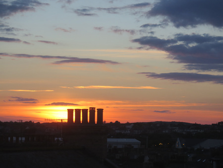 Silhouettes of chimneys in Red sunset in Weymouth, Dorset, UKの写真素材