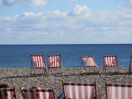 Deckchairs on the beach in Beer, Devonの写真素材