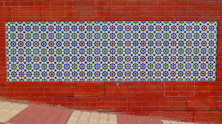 Wall tiled with colorful floral ceramic tiles