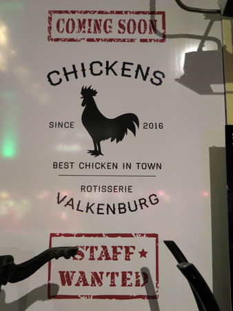 Valkenburg, The Netherlands - December 20, 2016: Advert showing Cockerel on poster for new Chicken restaurantのeditorial素材