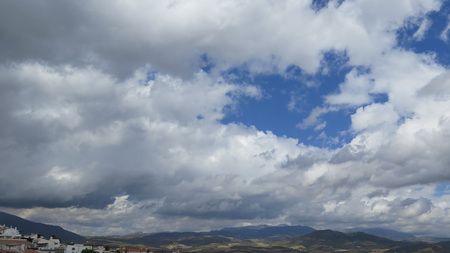 Patch of blue sky over village and valley in Andalusiaの写真素材