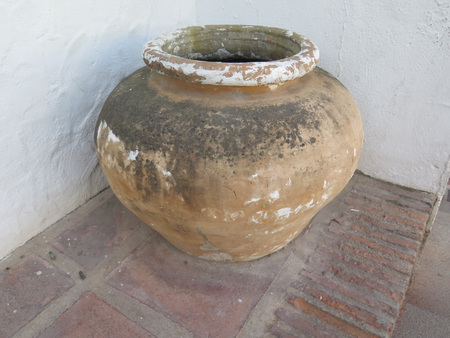 Large empty earthenware pot in corner in Andalusian villageの写真素材