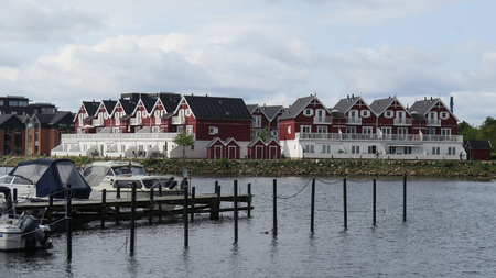 Red painted Wooden houses on water frontのeditorial素材