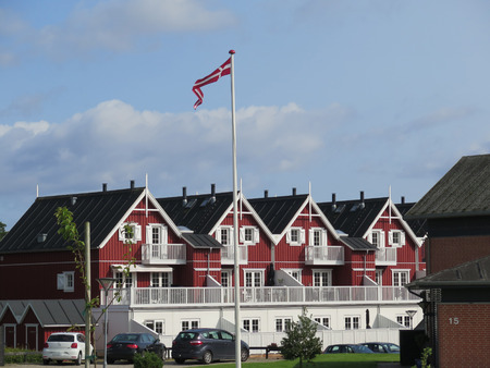 Graasten, Denmark - August 22, 2017: Wooden houses and Danish Flag flying in summer windのeditorial素材