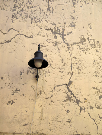Lone black wall lights on textured wallの写真素材