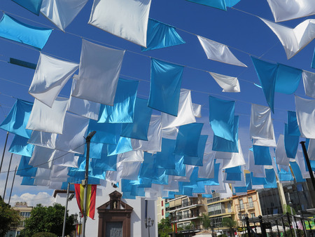 Fuengirola, Spain - October 4, 2017: Blue and white flags in Fuengirola church square, Andalusiaのeditorial素材