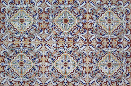 Closeup of Wall tiled with colorful ceramic tiles in village in Andalusia