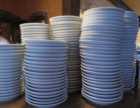Plates stacked high on restaurant counter in Hollandの写真素材