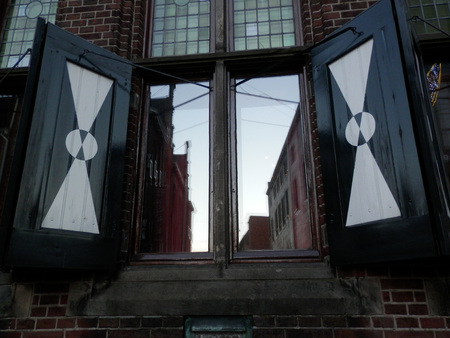 Wooden decorated shutters on house in Duch townの写真素材