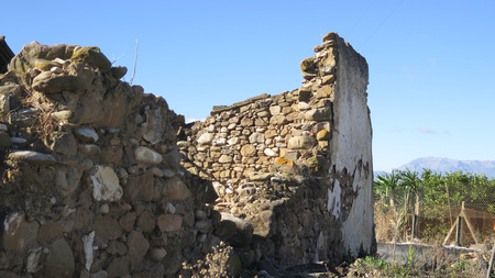 Thick stone and mud constructed wall remnants at abandoned farmhouse in Andalusiaの写真素材