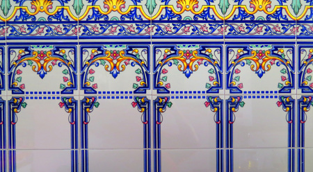 Intricate blue and gold tiled wall on shop wall in Tarifa, Andalusia