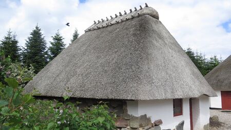 Thatched half timbered building on cobbled street in old Southern Danish villageのeditorial素材