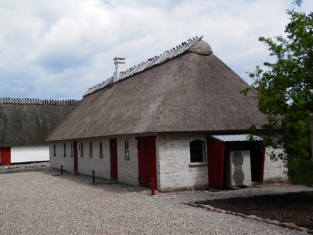 Holm, Denmark - May 27, 2019: Thatched farmhouse building on cobbled street in old Southern Danish villaageのeditorial素材