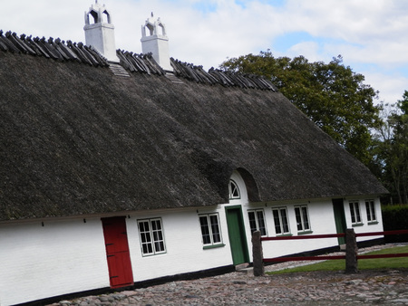 Holm, Denmark - May 27, 2019: Thatched farmhouse building on cobbled street in old Southern Danish villaageのeditorial素材