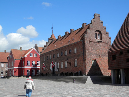 Ribe, Denmark - May 28, 2019: People enjoying sunshine on cobbled square in Southern Danish market...
