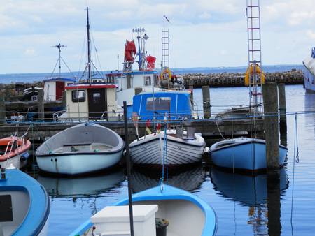 Small fishing boats moored in marina in Southern Danish sunshineのeditorial素材