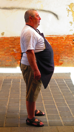 Alora, Spain - August 12, 2019: Local bar owner waiting for customers outside his cured ham shop and bar in Andalusian villageのeditorial素材