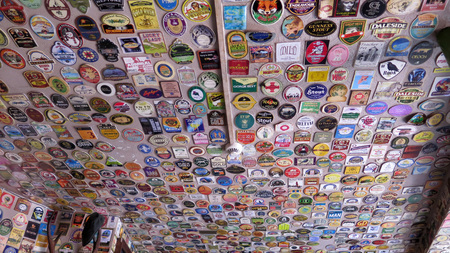 Reading, United Kingdom - August 9, 2019: Ale house walls and ceiling covered in colorful beer matsのeditorial素材