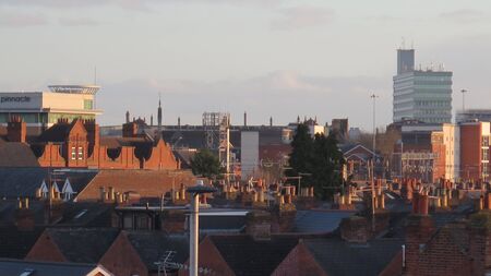 Rooftop view of a variety of different chimney pots on quaint cottagesand modern background...