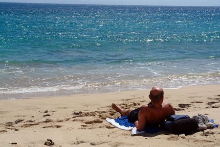  man sunbathing by the shore                              の写真素材