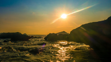 Beach and rocks in seaside. Beautiful dramatic ocean sunsetの写真素材