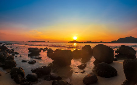 Beach and rocks in seaside. Beautiful dramatic ocean sunsetの写真素材