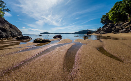 Tropical beach with rocks in West Sumatra coast, Indonesiaの写真素材