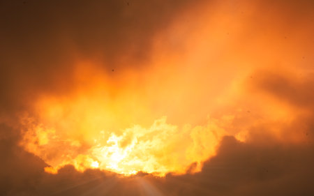 Sunset sky with clouds and sunbeams. Abstract background.の写真素材