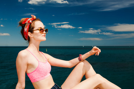 attractive girl model in sunglasses sunbathing on beach